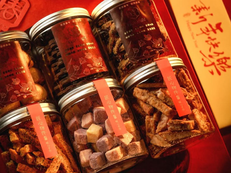 Jars of festive cookies beautifully arranged in a red gift box