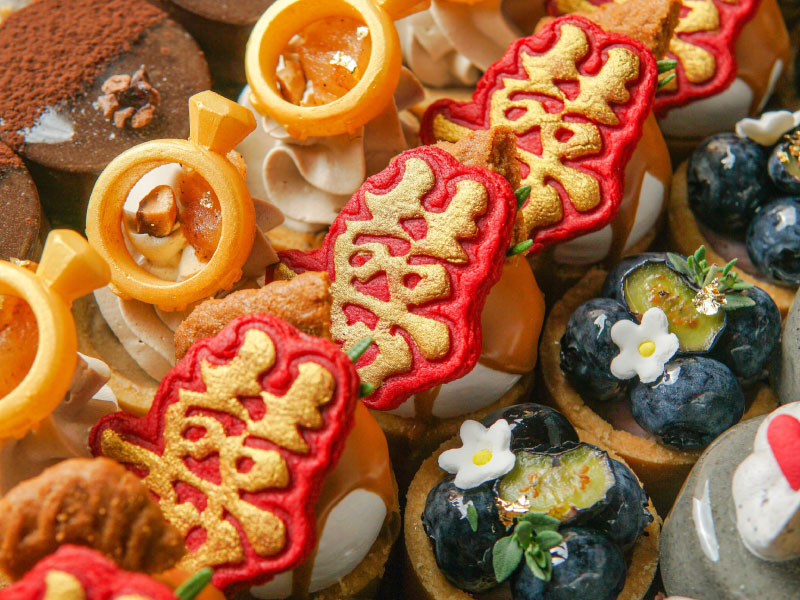 An assortment of decorated fruit and chocolate desserts for a celebration
